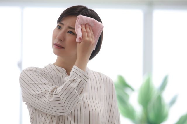 汗を拭う女性
